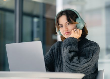 Person practicing interviews online with laptop and headphones